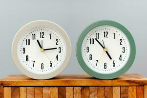 Alarm clock placed on a wooden plank working with time concept of time value of time photo