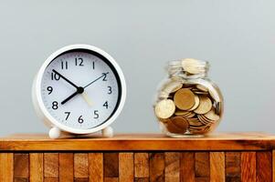 Coin bank, money and time, saving money on time, earning, income, wages, savings concept. photo