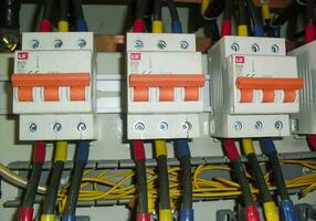 Voltage switchboard panel, electrical components at plant and factory with circuit breakers. photo