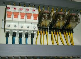 Voltage switchboard panel, electrical components at plant and factory with circuit breakers. photo