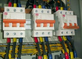 Voltage switchboard panel, electrical components at plant and factory with circuit breakers. photo