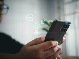A boy hand uses a smartphone to type live chat, ask, answer with an artificial intelligence system. chat bot. Ai. photo