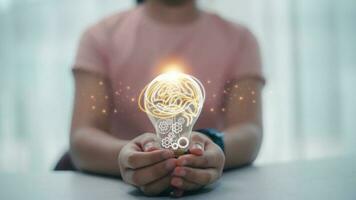 Light bulb with a brain inside the hands of the woman. The concept of the business idea concept. photo