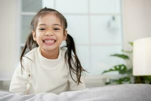 Happy Little Asian girl child with a big smile and laughing Healthy happy funny smiling face young adorable lovely female kid.Joyful portrait of Asian elementary school students. photo