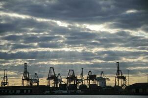 Heavy industry cranes in logistic bay area in the evening twilight scene photo