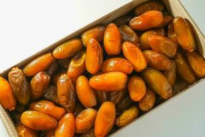 Fresh ripe yellow dates, fresh dates ruthob isolated on white background photo