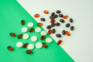 Many different tablet pills on color background, flat lay, with copy space. photo