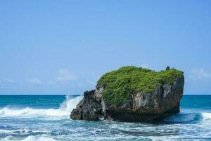 waves splashing on the rocks by the sea, in mesra beach photo