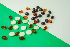 Many different tablet pills on color background, flat lay, with copy space. photo