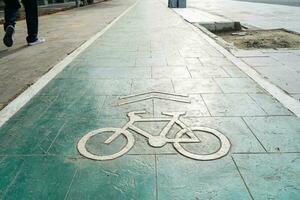 bicycle lane, traffic, city transportation and eco-friendly concept, green bicycle lane with bicycle signs photo