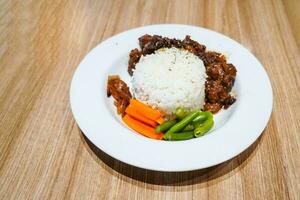 Boiled beef rice, with healthy and delicious chunks of green beans and carrots photo