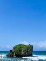 waves splashing on the rocks by the sea, in mesra beach photo