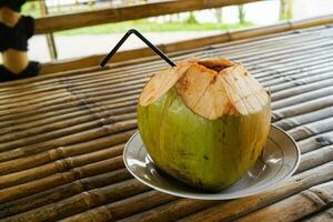 Fresh green coconut, young coconut ready to drink photo