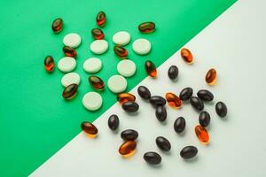 Many different tablet pills on color background, flat lay, with copy space. photo