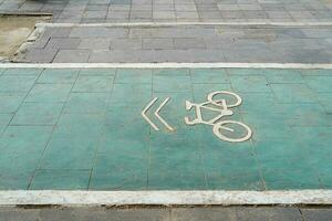 bicycle lane, traffic, city transportation and eco-friendly concept, green bicycle lane with bicycle signs photo