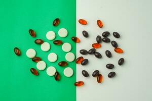 Many different tablet pills on color background, flat lay, with copy space. photo