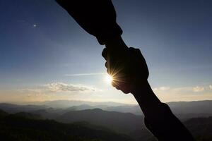 silhouette of helpping hand and hope concept and international day of peace.how can i help you photo