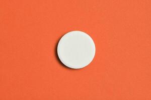 Effervescent tablet isolated on orange background photo