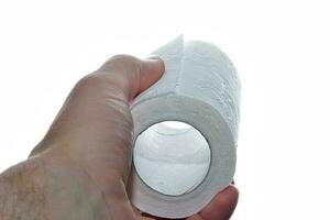 Toilet paper in the hand against white background photo