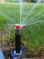 automatic irrigation system for the garden near the sidewalk photo