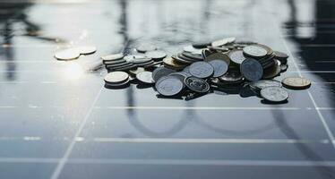 Silver coins on the solar panel help store solar energy. photo