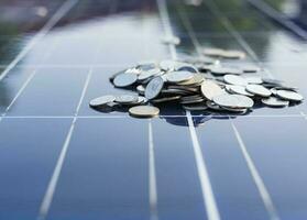 Silver coins on the solar panel help store solar energy. photo