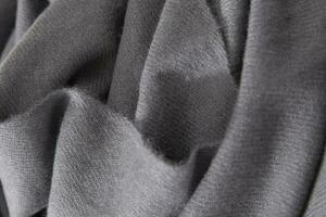 Natural wool grey fabric. Cashmere, wool. Texture of natural wool fabric. Knitwear. photo