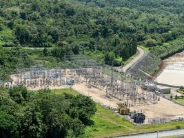 The hydroelectric power plant near the large earth dam. photo