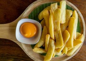 The golden french fries in the wooden plate. photo