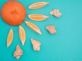 Orange,lemons and seashells sun. Summer, flat lay, blue background photo