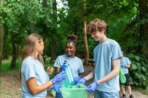 A group of local people gather to clean up their local park. Mixed age groups collect garbage. They squat in nature and collect garbage. photo