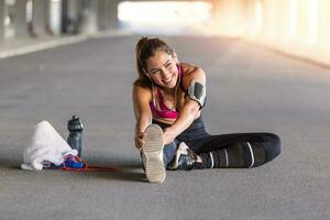 Fitness sport girl in fashion sportswear doing yoga fitness exercise in the street, outdoor sports, urban style. Young sporty woman training. Woman Doing Workout Exercises On Street. photo