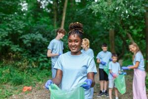 Volunteers collecting garbage from park, environmental awareness is important to save our planet photo