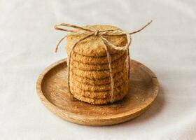 Oatmeal cookies on a wooden plate photo