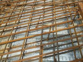 A series of iron bars arranged in such a way with a certain distance of two layers for the reinforcement of the concrete slab structure of the bridge. photo