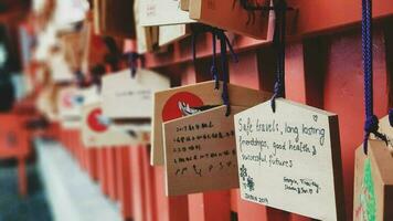 Kyoto, Japan in April 2019. Wish and prayer board or commonly called Ema. Ema are small wooden plaques, common in Japan, on which Shinto and Buddhist devotees write prayers photo