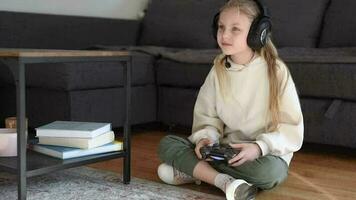Little girl playing internet video game using remote controller