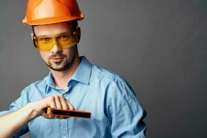 man wearing yellow glasses with orange paint safety work service photo