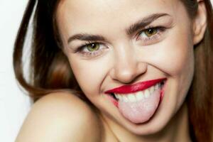 Cheerful woman shows tongue face close up joy photo
