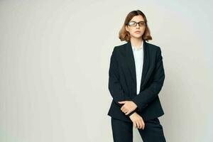 Business woman in black suit wearing glasses self confidence office photo