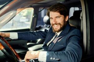 bearded man Driving a car trip luxury lifestyle success service rich photo