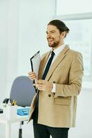 man in beige jacket official documents work office technologies photo