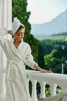 Woman in a bathrobe enjoying her morning at the balcony Perfect sunny morning photo