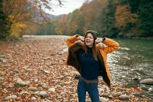 joyful woman in nature Autumn forest river freedom photo