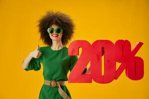 pretty woman green dress afro hairstyle dark glasses twenty percent in hands studio model unaltered photo