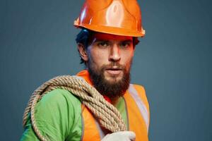 A working man in an orange paint rope in the hands of a construction professional photo