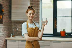 pretty woman kitchen glass of water apartment kitchen utensils interior unaltered photo