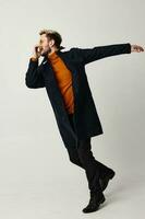 man black coat movement dance fashion modern style isolated background photo