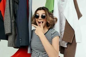 pretty woman with glasses next to clothes fashion fun emotions photo