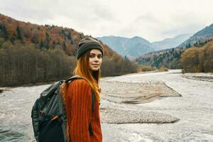 retrato de mujer viajero en montañas al aire libre cerca río paisaje recortado ver foto
